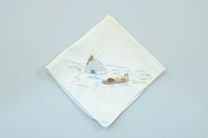 Image of Figure standing by snowhouse and sledge packed with provisions, one of a set of 4 embroidered napkins with scenes of Inuit ice life